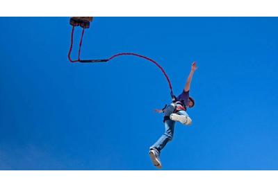 man in mid air on free fall device