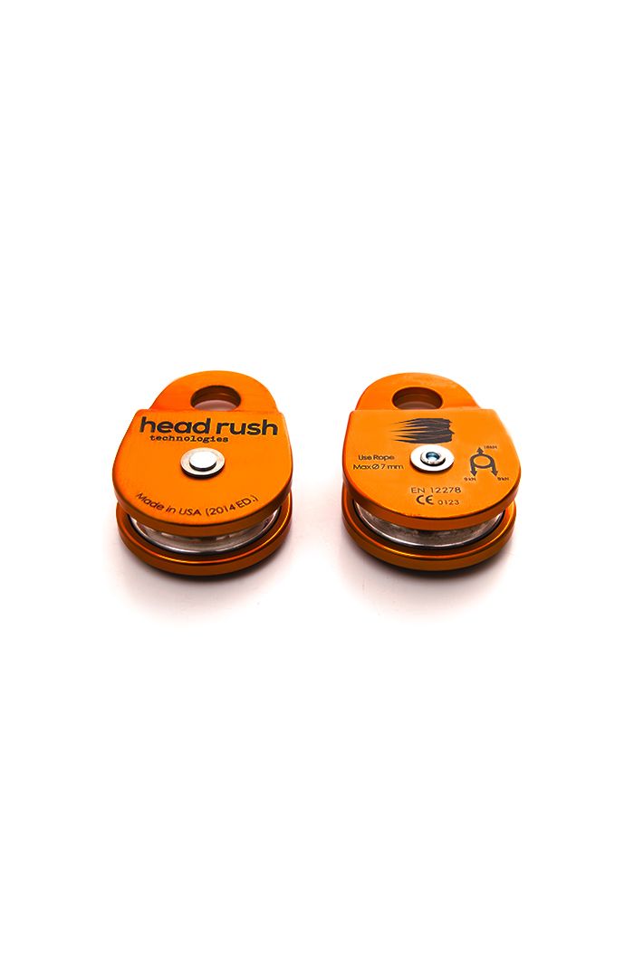 front and back of orange zipSTOP precision zip line pulley for zip line redirection lines