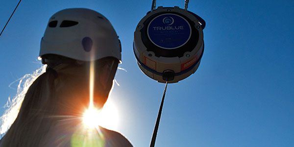woman silhouetted by the sun attached to TRUBLUE Auto Belay
