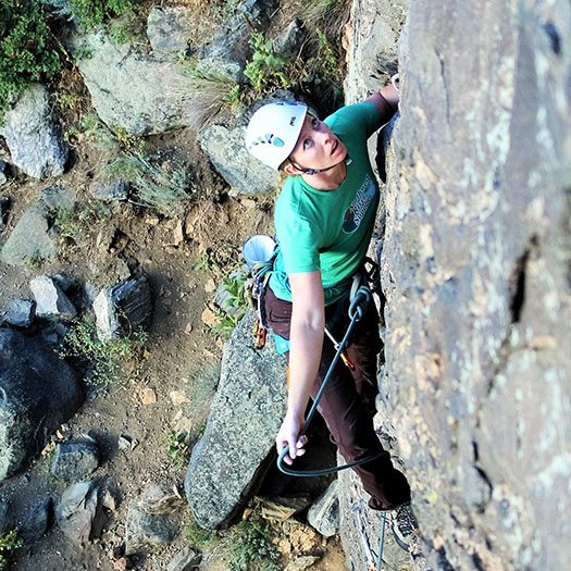 dana leading a rock climbing route