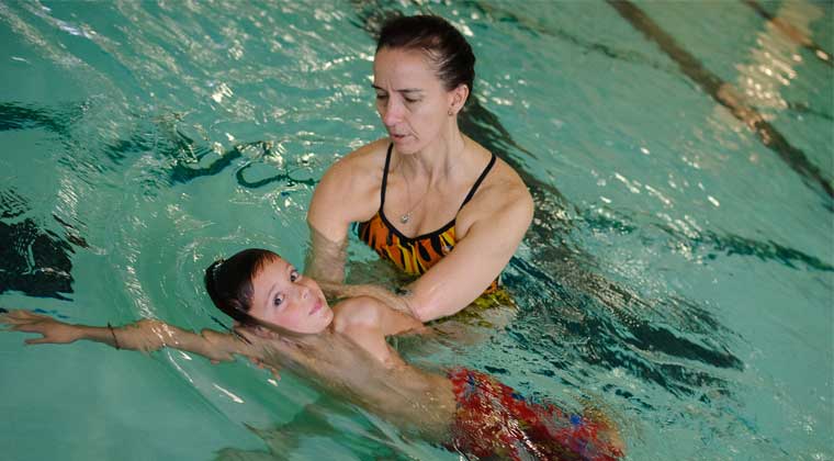 mom with kid at swimming pool