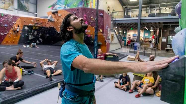 Male Climber Prepares to Scale Climbing Wall with TRUBLUE IQ Auto Belay