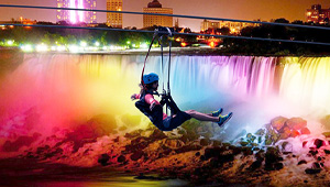 Zip lining with a lightshow waterfall in the background