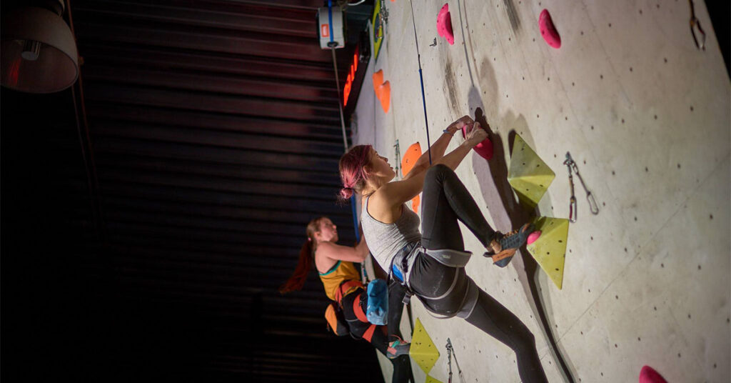 Climbers using TRUBLUE auto belay system on an indoor climbing wall
